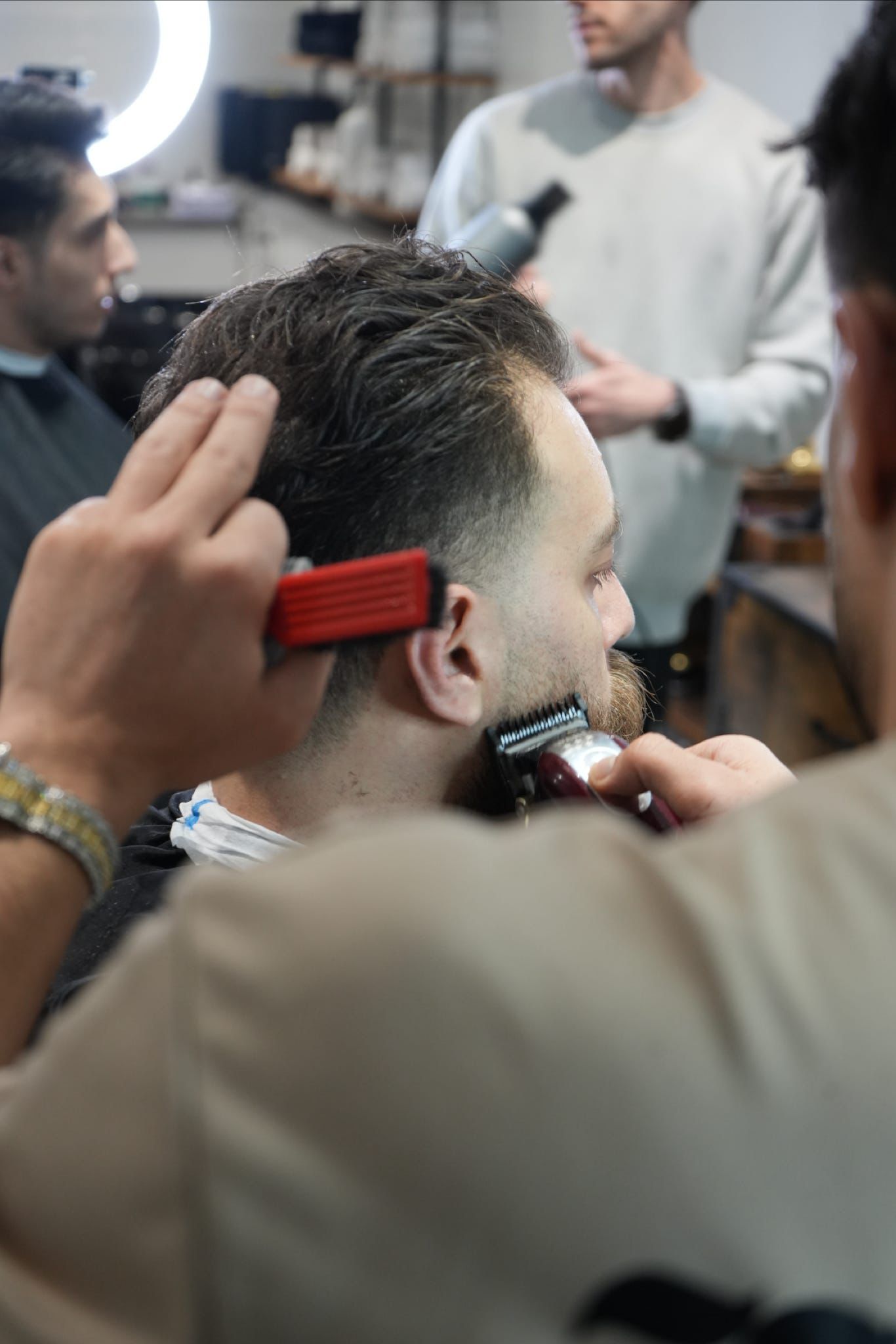 Barber in action at Kaz Barbershop